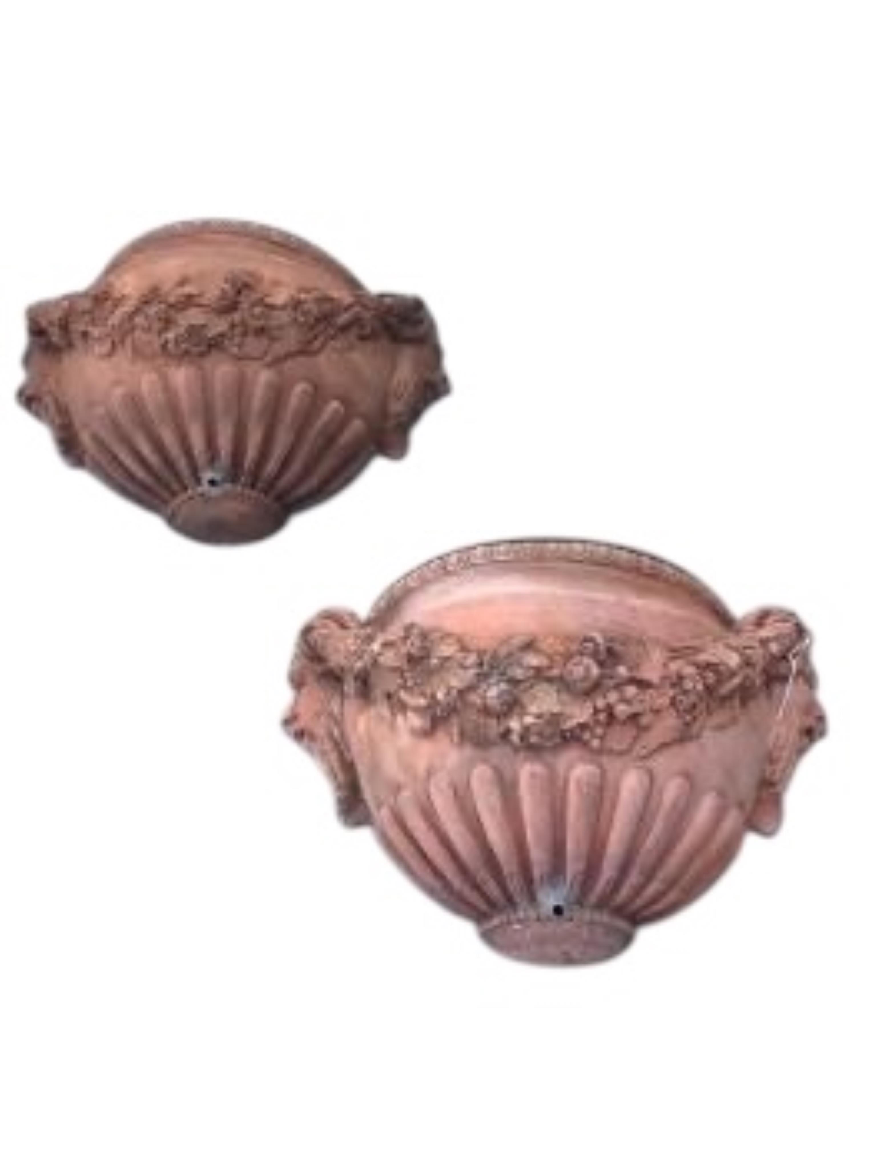A pair of terracotta wall pocket garden fountains, width 46cm, depth 16cm, height 27cm